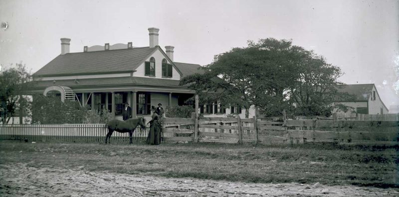 The house and barn at 28 Main Street, Siasconset, with two men, two women, and a pony out in front.